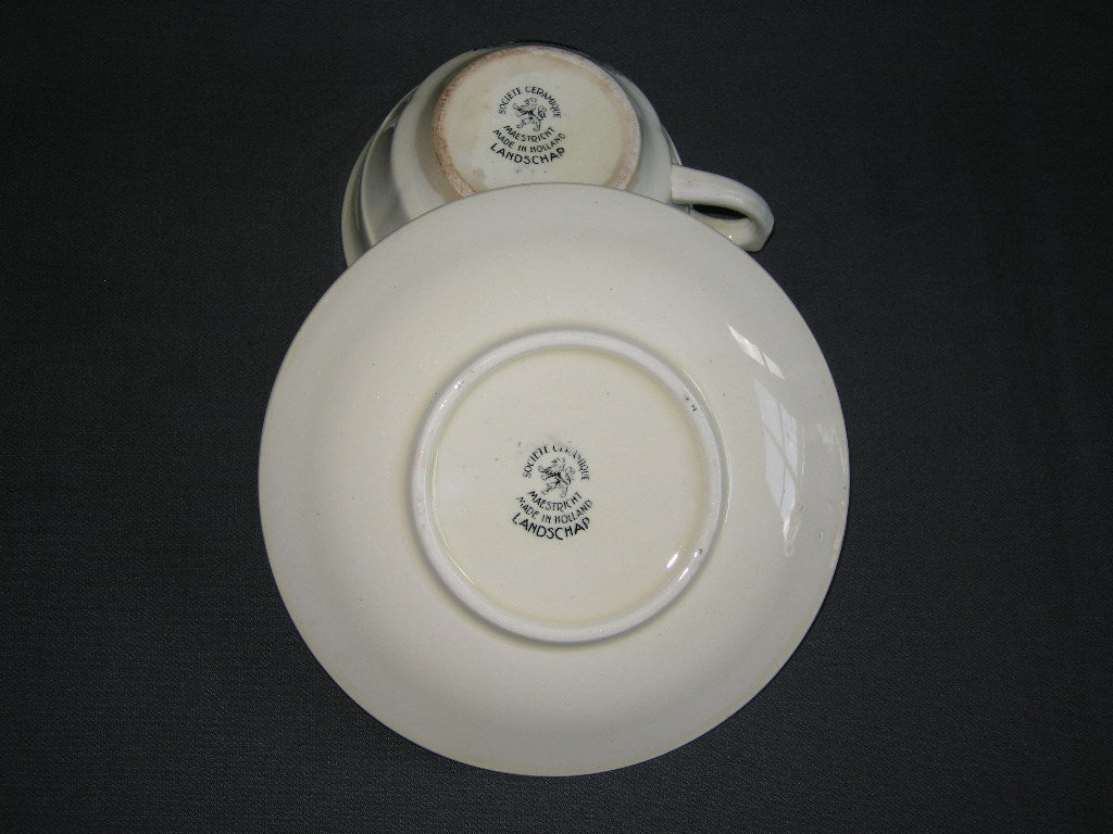 Societe Ceramique Landschap cappuccinokop & schotel met flinke verkleuring