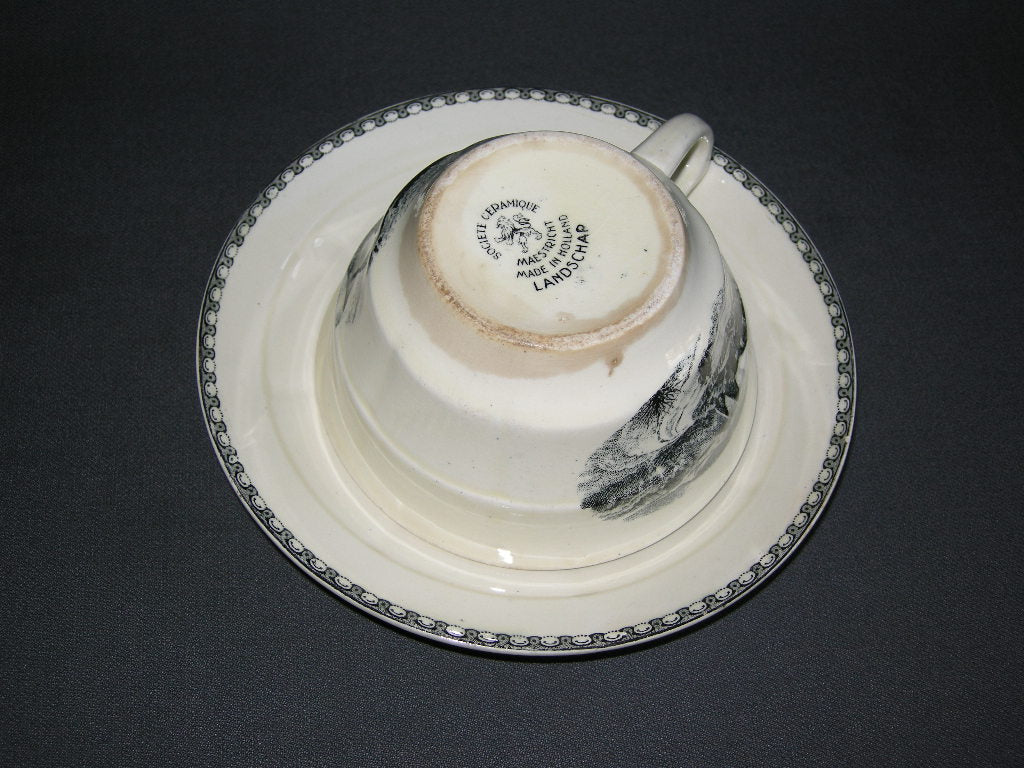Societe Ceramique Landschap cappuccinokop & schotel met flinke verkleuring